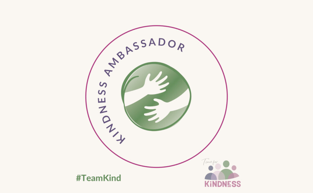 A digital kindness ambassador badge with the words wrapped around an illustration of 2 arms and hands encircling the world and the Time for Kindness logo in the corner