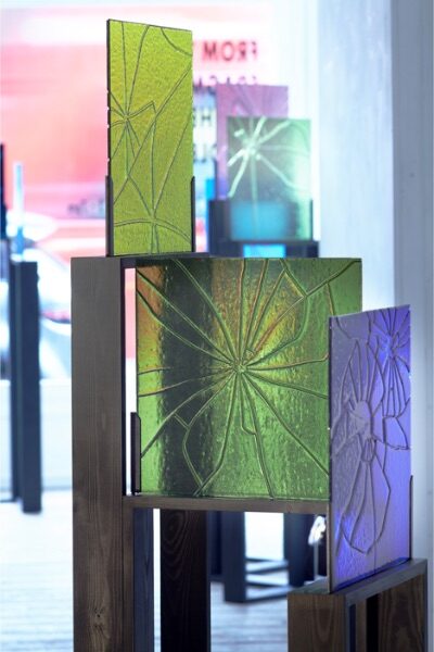 Several pieces of coloured glass shattered and stuck back together on show during an exhibition.