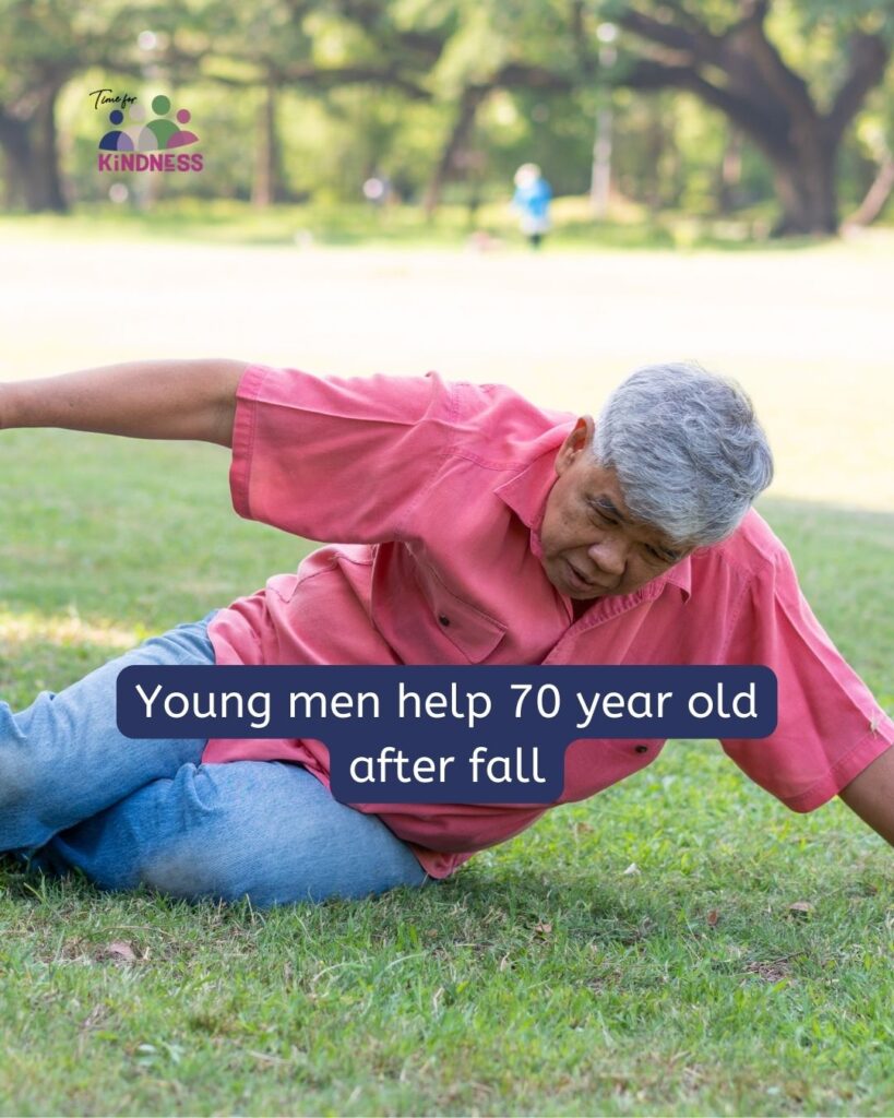 A man with medium dark skin tone and grey hair on a grassy area, one arm reached out to brace himself, the other going off the other way.