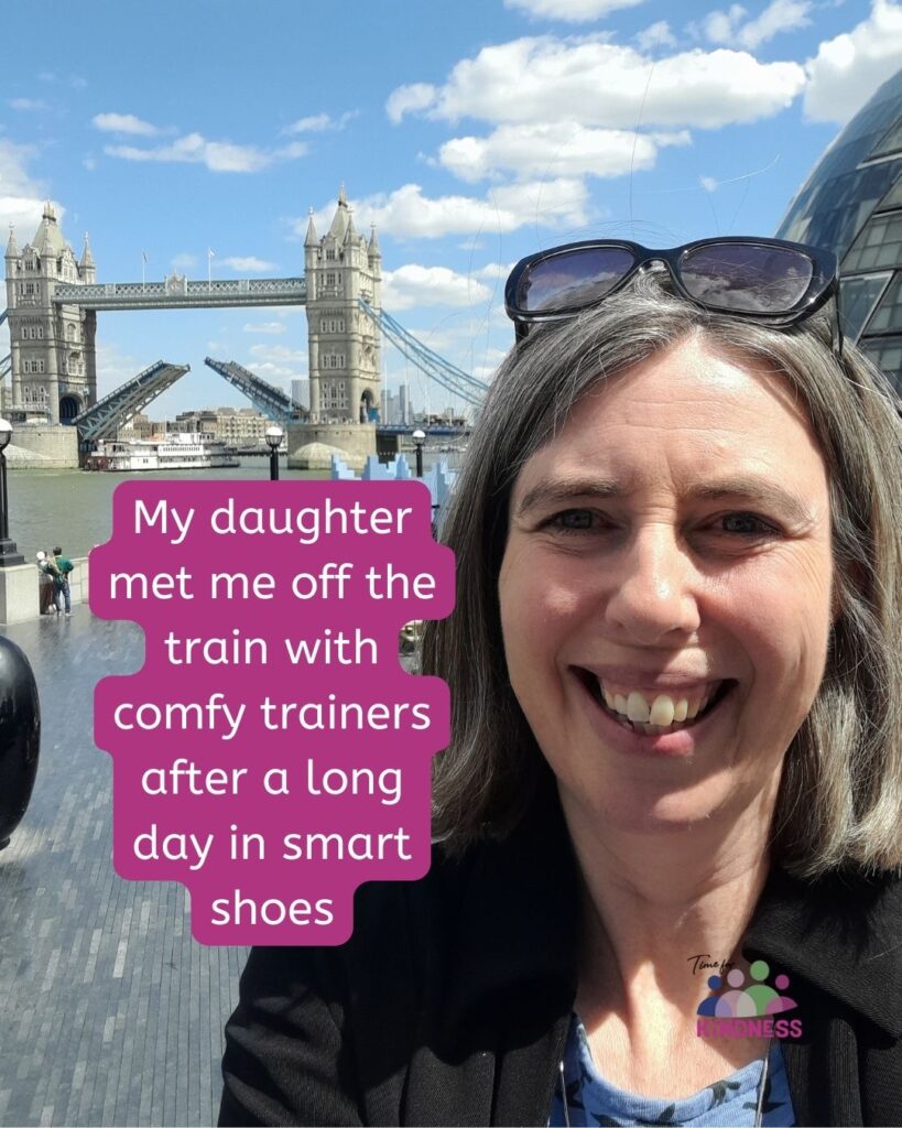 Sarah smiling broadly in front of London Bridge as it opens. Text overlaid reads "My daughter met me off the train with comfy trainers after a long day in smart shoes."