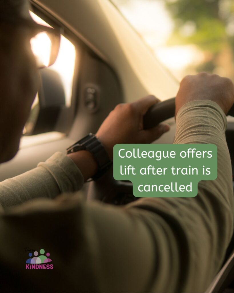 view from just behind the driver of a car of their hands on the wheel, a black watch on one wrist. They are wearing long sleeves. Text overlaid reads “Colleague offers lift after train is cancelled.”