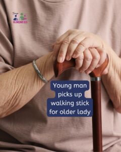 Elderly hands resting on a wooden walking stick. Text overlaid reads “Young man picks up walking stick for older lady.”