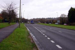a two lane road with footpath on the side.