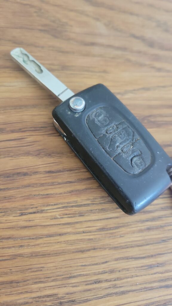 a van key which looks very well worn laying on a table.