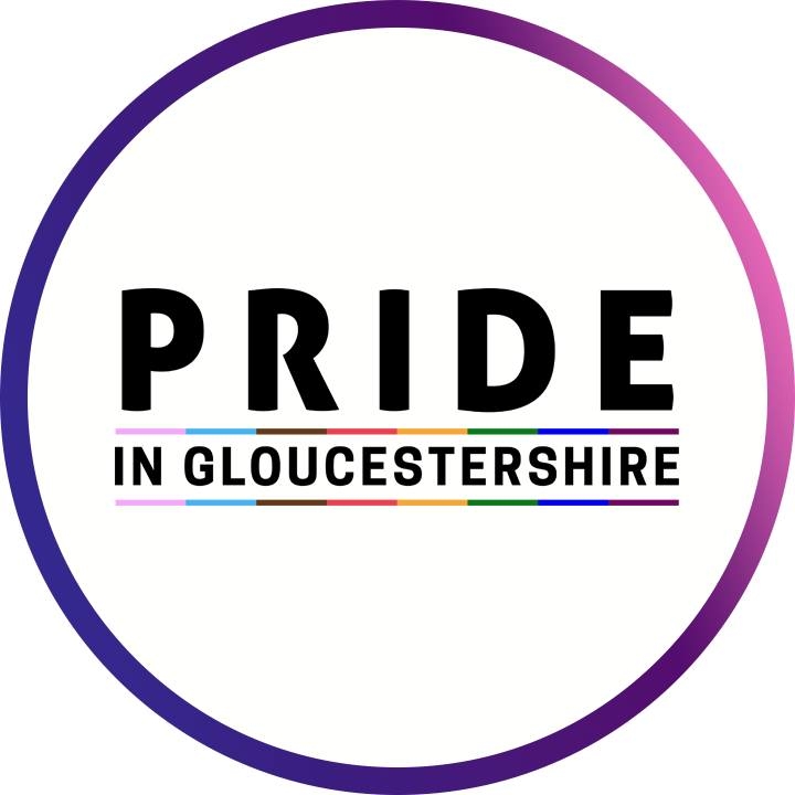 Block black text reading “Pride in Gloucestershire” with the trans and progress pride colours creating an underline. The text is in a circle which fades from pink to purple.