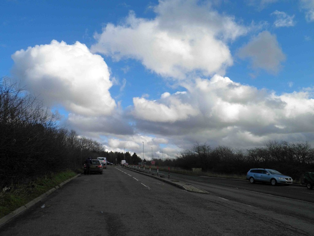 a layby with some vehicles parked in it.
