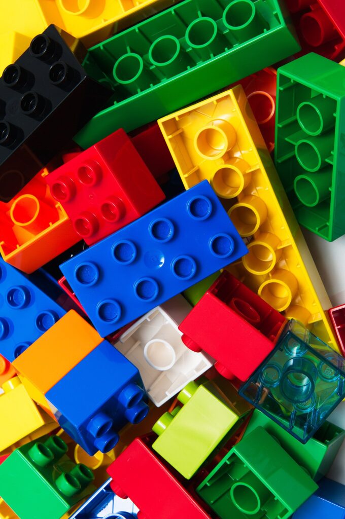 close up of a selection of brightly coloured Lego blocks all overlapping each other.