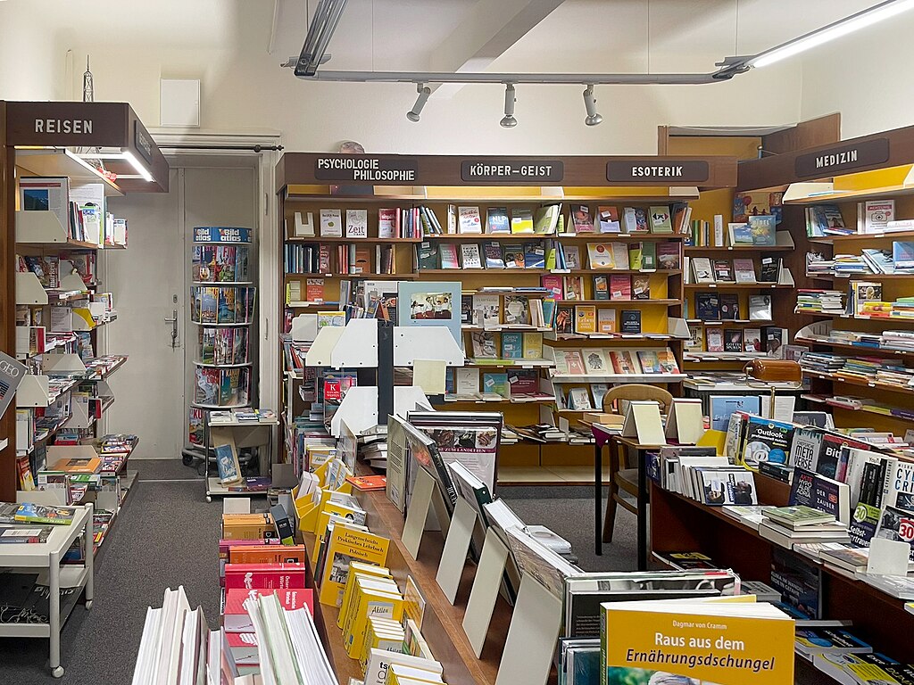 a German library or book shop filled with books in different sections