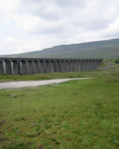 Ribblehead Viaduct in Yorkshire on a murky, cloudy day.